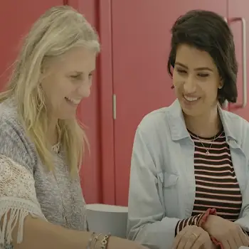 Two women sitting together smiling